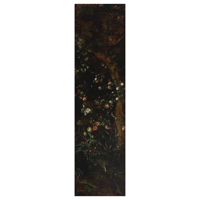 A tree with roses climbing the trunk