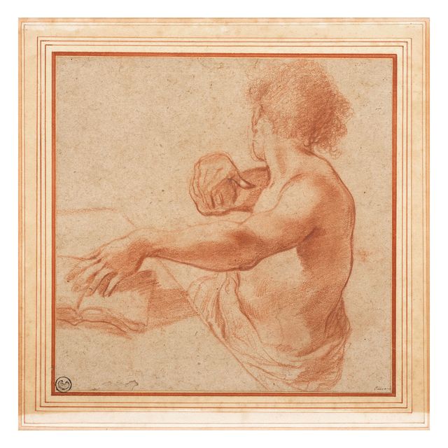 Young man seated at table turning away